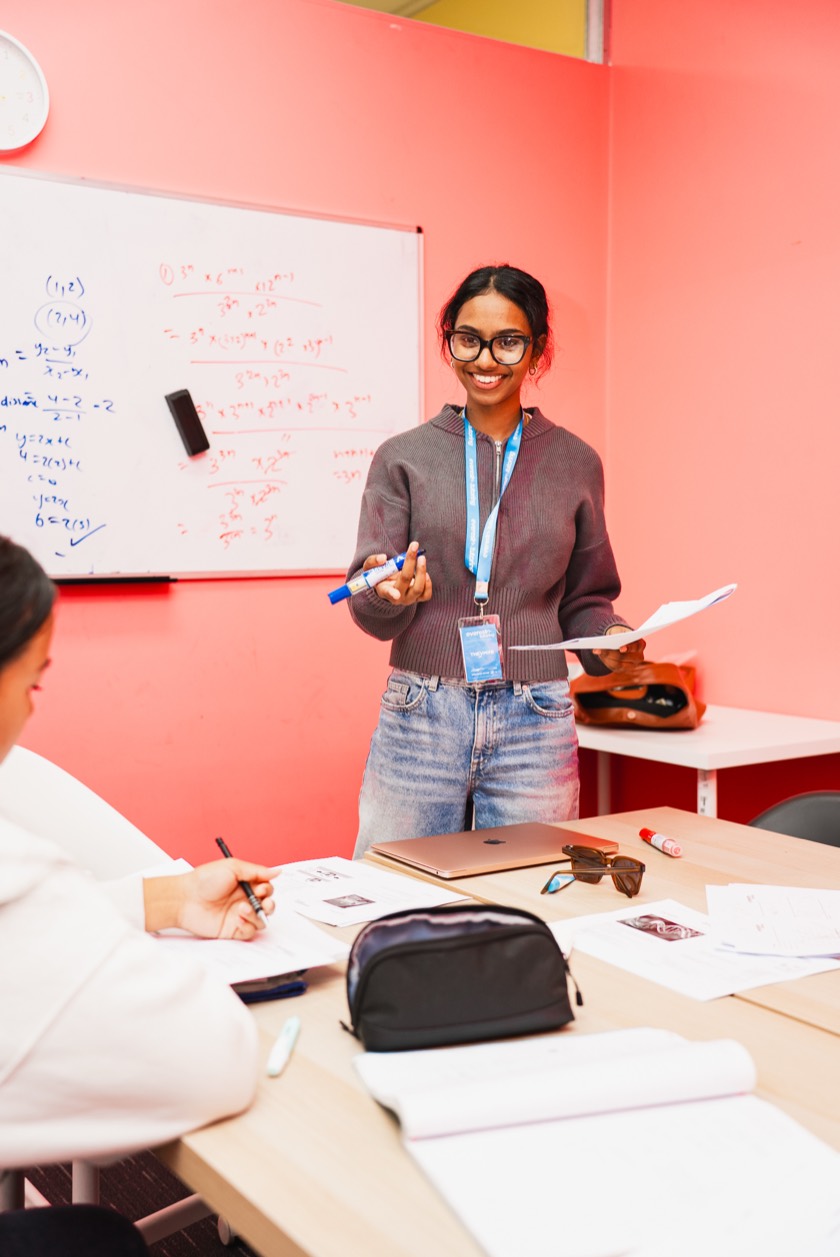 An Everest tutor explaining algebra at the whiteboard during a Maths class at Harrisdale SHS