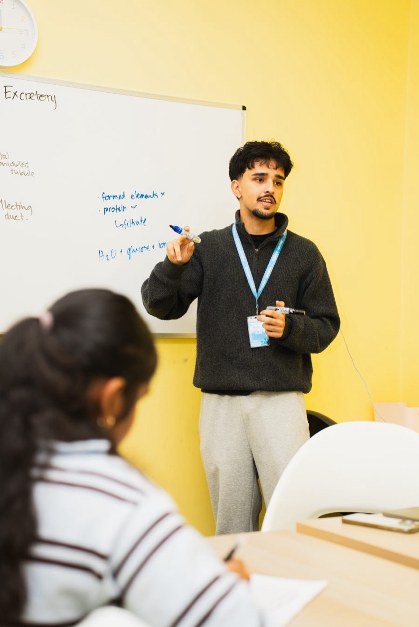 An Everest tutor teaching a biology topic at the whiteboard during a Science class